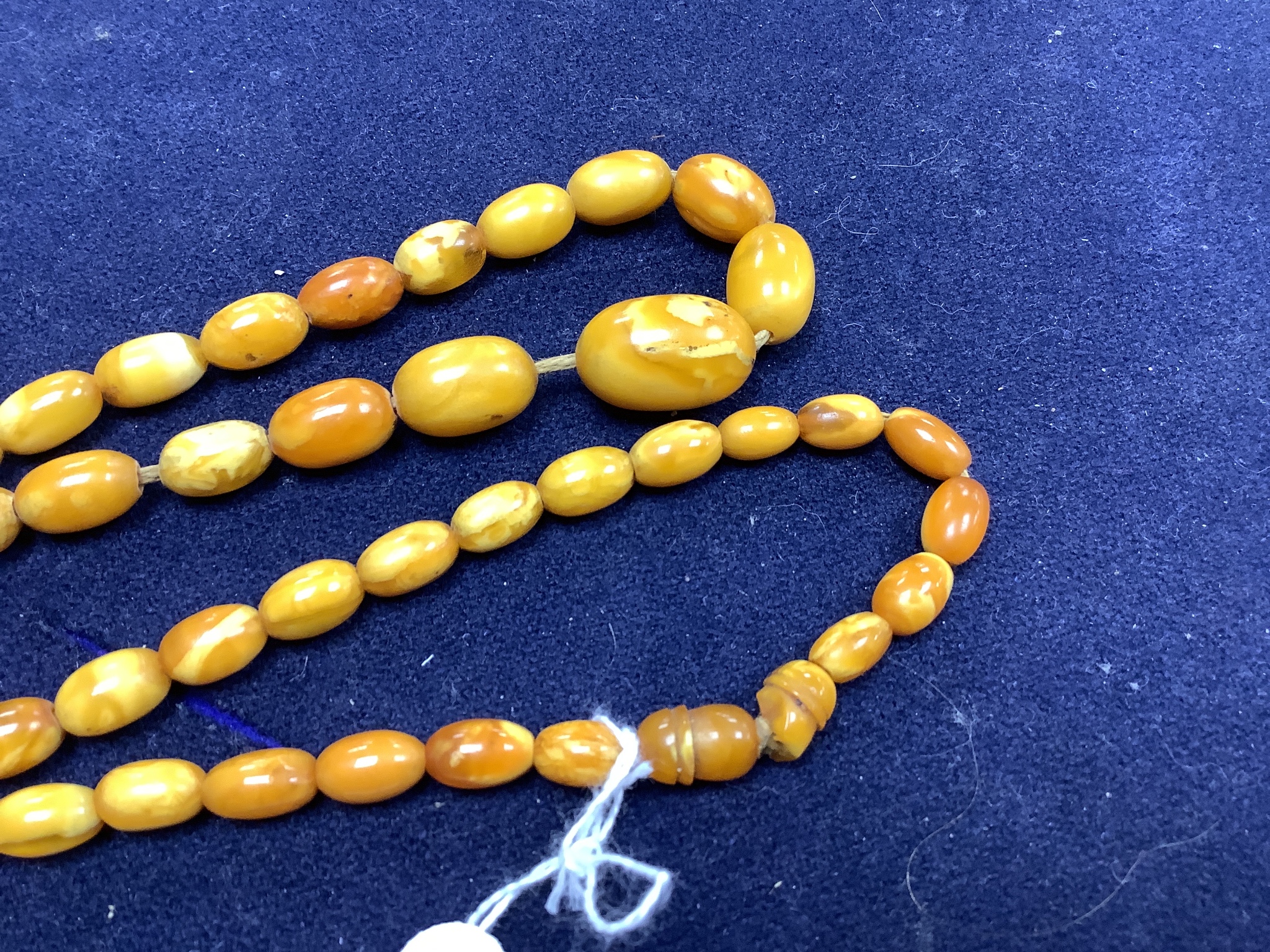 A string of amber beads and a specimen piece of Baltic amber